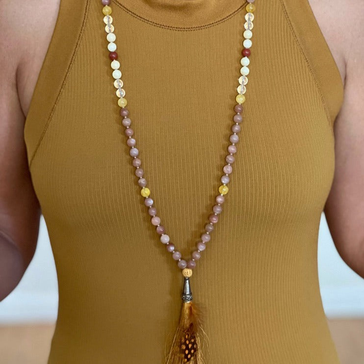 women wearing sunstone necklace with tassel 