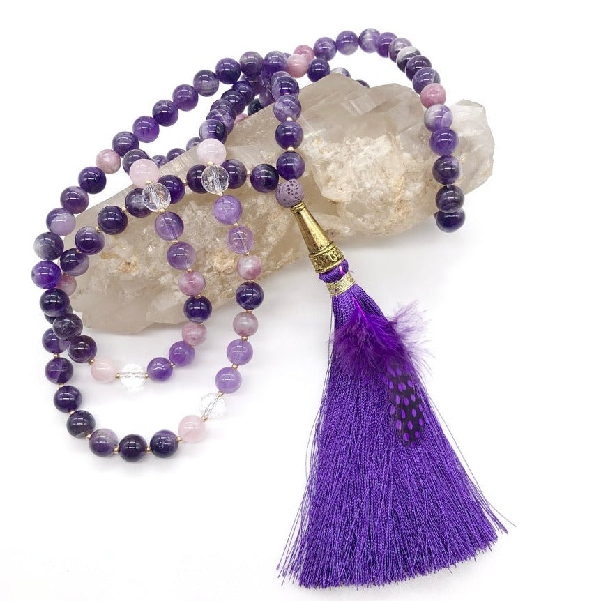 Amethyst crystal necklace with purple tassel on top of smokey quartz crystal 
