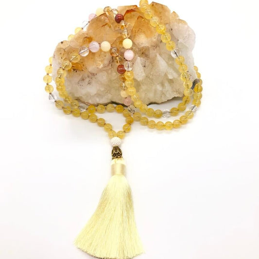 Citrine crystal necklace on top of a citrine stone