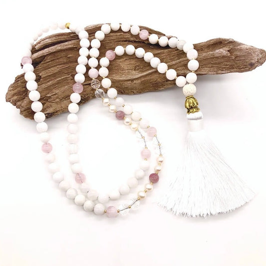 real moonstone necklace with white tassel on top of wood