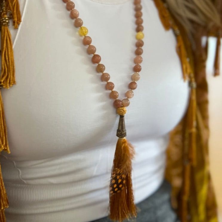 women wearing orange sunstone necklace with tassel and citrine stone