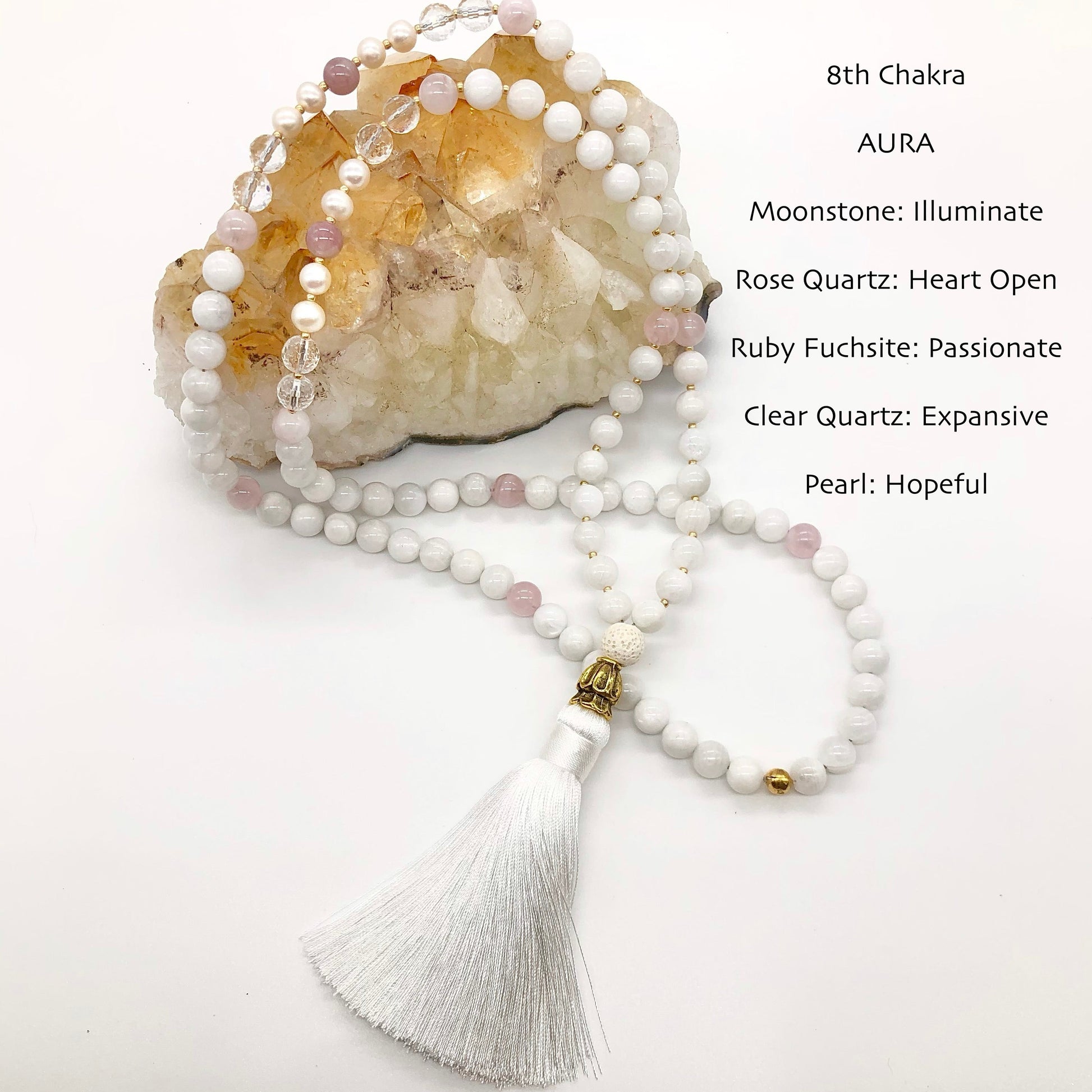 real moonstone necklace sits on tip of citrine crystal
